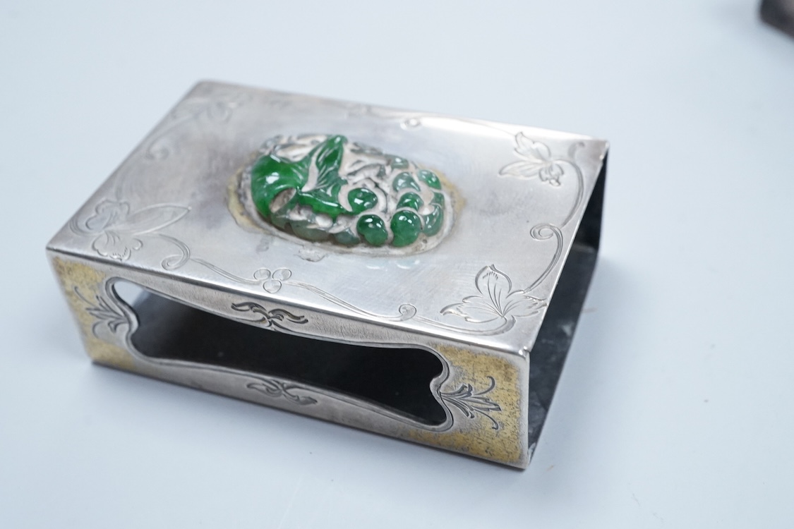 Two North American Edward I. Farmer of New York engraved sterling matchbox slides, one mounted with a jadeite carving, the other with polychrome enamelled surmount, both approximately 60mm.